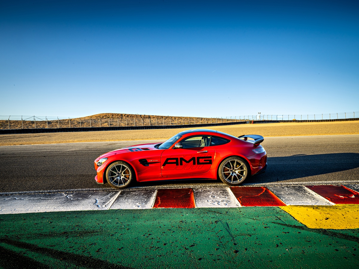 Red Mercedes AMG Vehicle parked on Laguna Seca Raceway from side view