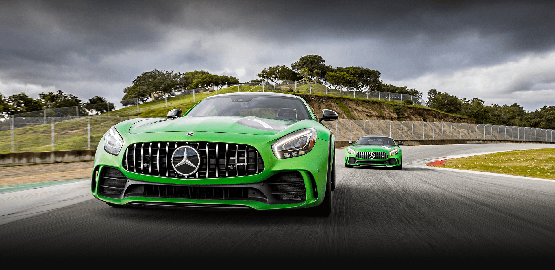 Two green Mercedes AMG Vehicles on Laguna Seca Raceway in Salinas, CA