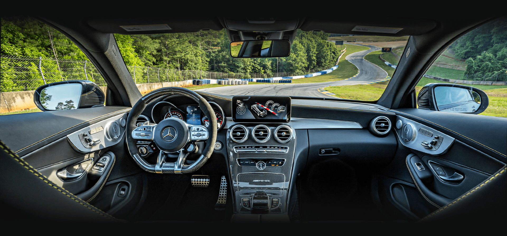 Digital cockpit of Mercedes-AMG vehicle overlooking race track