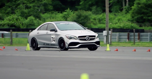 Silver Mercedes-AMG Vehicle maneuvering between yellow and orange cones