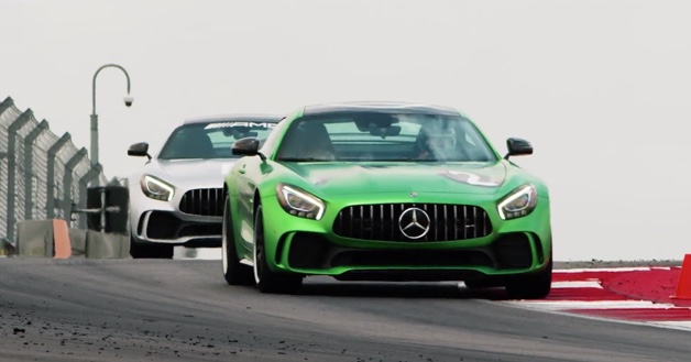 White and green Mercedes-AMG vehicles racing on track